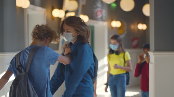 Schoolboy Being Bullied By Classmates in School Corridor