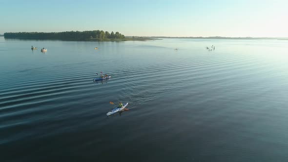 Aerial Drone Footage. Tourists Are Kayaking. Beautiful Sunrise Over River