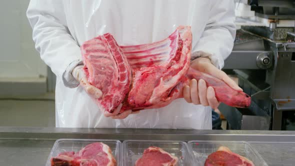 Butcher holding red meat