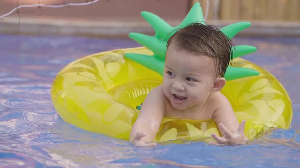 Cute Asian Little Boy In The Pool