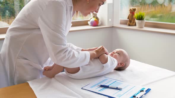 Female Pediatrician Doctor with Baby at Clinic