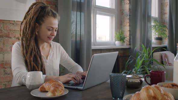 Female Freelancer Working During Breakfast