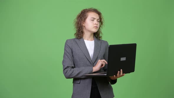 Young Happy Beautiful Businesswoman Thinking While Using Laptop