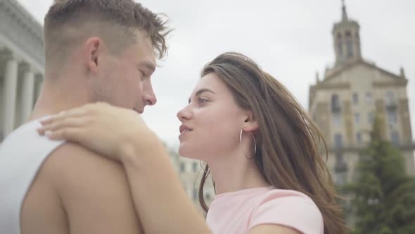 Close-up of Young Loving Caucasian Couple Dancing on City Square. Portrait of Happy Joyful Man and