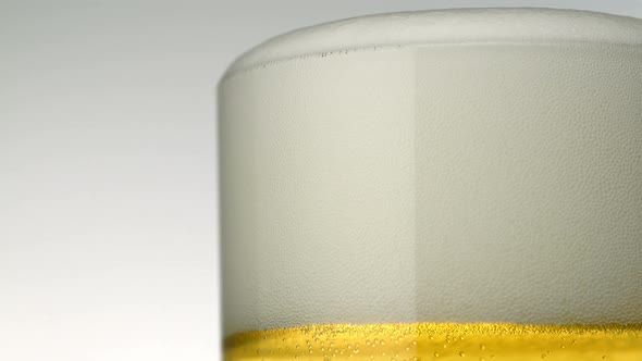 Beer foams over glass, Slow Motion