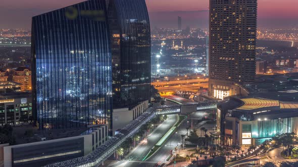 Dubai Downtown Street with Busy Traffic and Skyscrapers Around Night to Day Timelapse