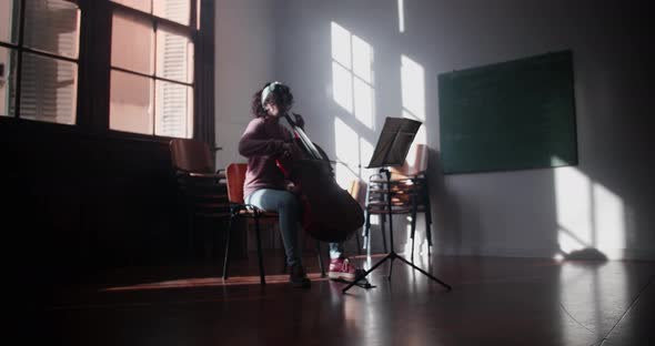 Cellist Rehearsing In Classroom