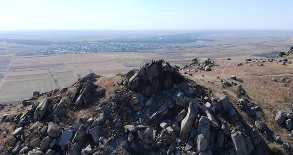 Aerial View Of Macin Mountain With Rocks And Crags Overlooking Countryside Field In Summer In Tulcea
