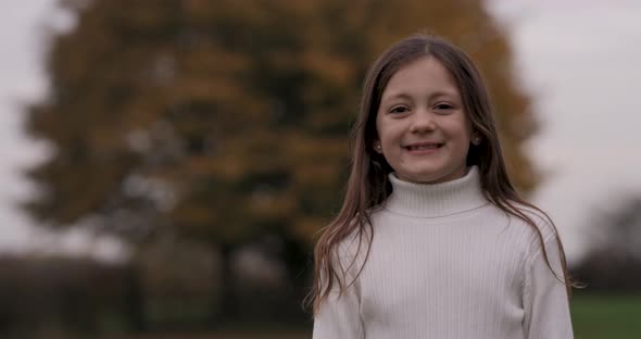 Portrait shot of a cute little girl smiling and looking at camera