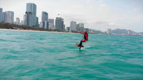 Acrobatic Jump of Professional Kite Surfer on the Sea Wave, Athlete Showing Sport Trick Jumping with