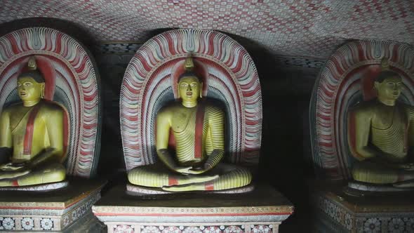 DAMBULLA, SRI LANKA - FEBRUARY 2014: The view of three sitting Buddhas at the Golden Temple of Dambu