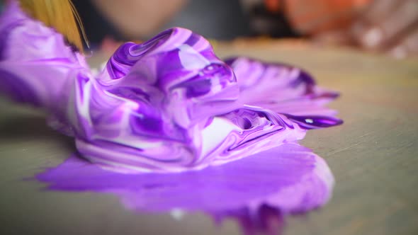 Closeup Shot of Artist Holding Paint Brush and Mix Color on Wooden Palette