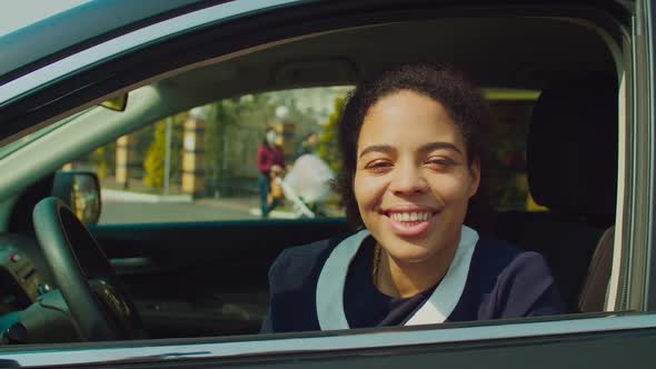 Pretty African Female Driver Giving Thumb Up in Car