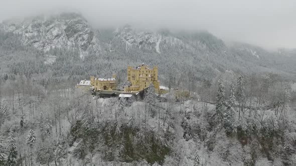 Aerial View Of Hohenschwangau getting altitude while flying towards