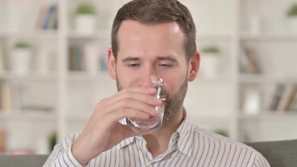 Young Man Drinking Water, Taking Sip