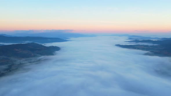 4K Aerial video Beautiful sunrise above dense clouds and fog in the morning