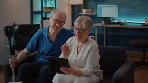 Senior Couple Talking to Relatives on Online Conference Call