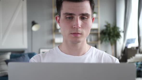 Close Up of Thinking Man Working on Laptop