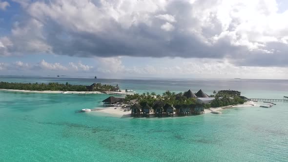 Drone shot of a Maldives island with dramatic clouds Full HD