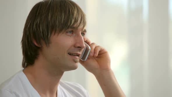 Young man talking on cell phone, closeup