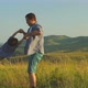 Father is holding his son and spinning around on scenic background - VideoHive Item for Sale