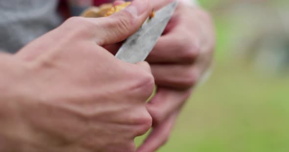 Young Man Cleaning Mushroom After Picking It. Autumn Discovery, Nature Products