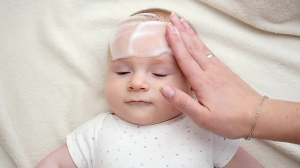 Cute Little Baby Boy Suffering From Dermatitis Being Cured with Medical Ointment and Suds