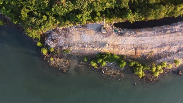 Aerial view excavator dredging at landfill