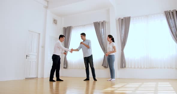 Asian Agent Giving Keys Of New House And Handshake With Customer
