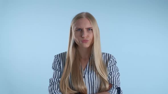 Offended Blonde Woman Refusing to Do Something on Blue Background