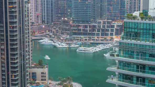 Aerial View of Dubai Marina Residential and Office Skyscrapers with Waterfront Day to Night