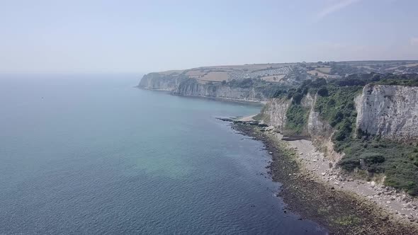 Slow fly over Jurassic Coastline bluff in Seaton, United Kingdom.