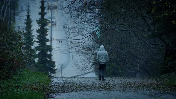 Man Walking On Cold Wet Day