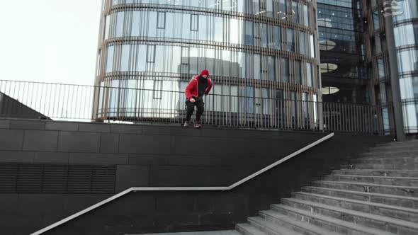 Parkour Athlete Jumping over Railings and Running in City Downtown