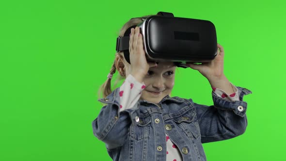 Child Girl Using VR App Helmet To Play Simulation Game, Drawing. Watching Virtual Reality 3d Video