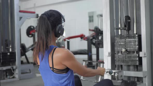 Close Up Young Woman Working Out in Modern Gym Young Asian Girl Doing Exercises in the Gym