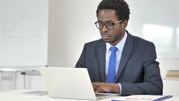 African Businessman Working On Laptop