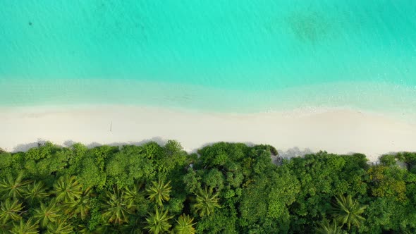 Wide birds eye abstract view of a white sand paradise beach and blue ocean background in colorful 4K