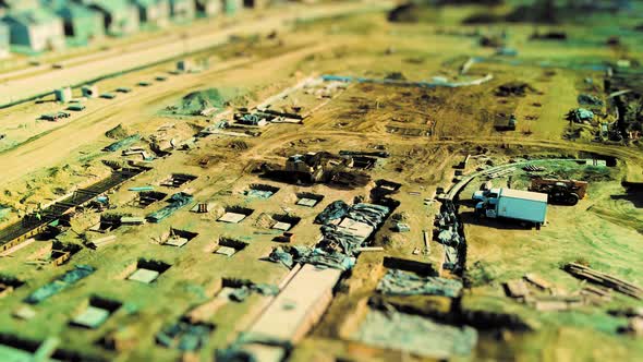 Large construction site with heavy equipment and people at work - aerial time lapse tilt shift effec