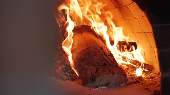 Close-up Movement with a Slider As in a Pizza Oven Burns Freshly Freshly Thrown Firewood Just Fine