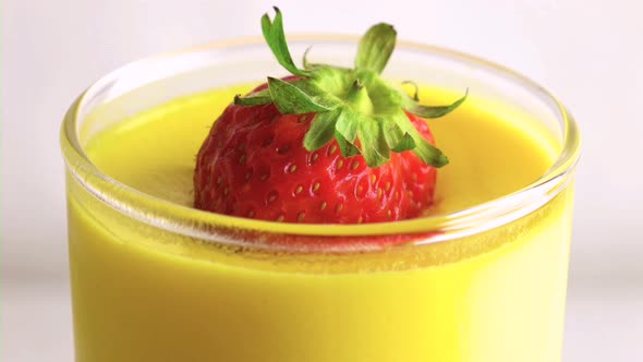 Orange juice with strawberry topping