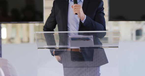 Male speaker addressing the audience at a business conference