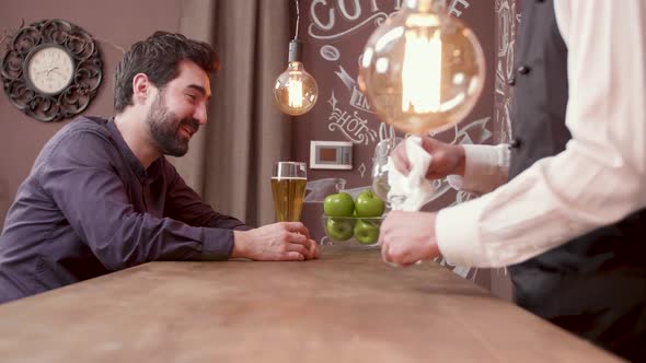 Man Laughs and Having Fun While Drinking a Glass of Beer