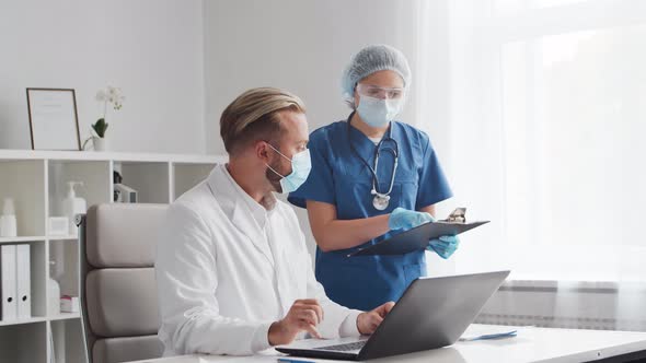 Professional medical doctors working in hospital office. Physician and the young nurse.