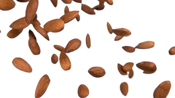 Closeup of Delicious Almonds Flying on a White Background