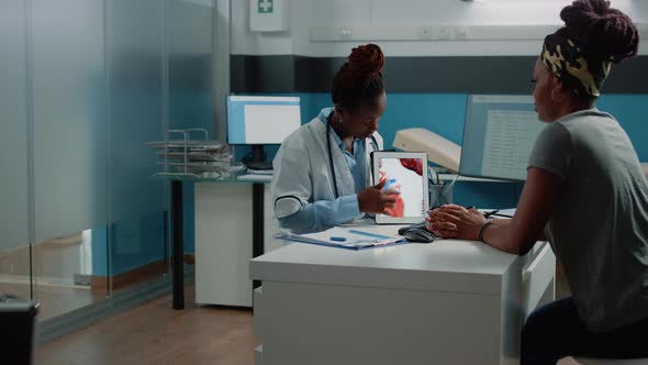 Doctor Showing Tablet with Heart Figure for Cardiology Checkup