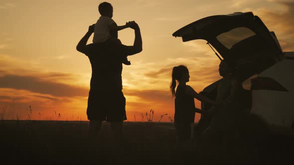 Silhouette the Happy Family of Four People, Mother, Father and Two Children Are Happy Sitting in the