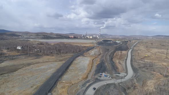 Aerial view of copper plant and road. Smoke comes out of the chimney. 26