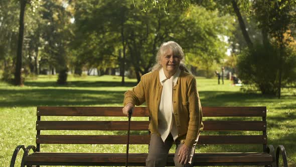 Old Woman Enjoying Sunny Day in Park, Suffering Back Pain, Health Problems