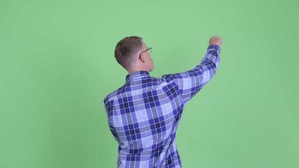 Rear View of Hipster Man Pointing Finger and Directing